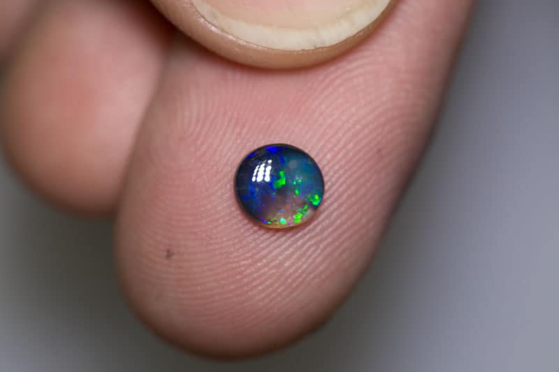 0.48 ct black opal 6mm round x2mm