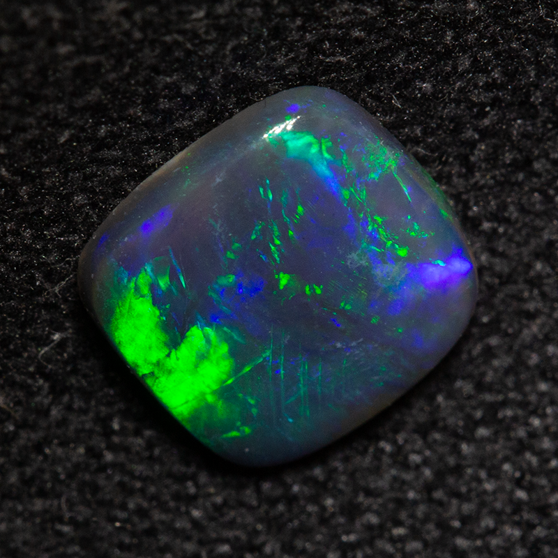 0.56 ct black opal 6.6x6.5x1.6mm