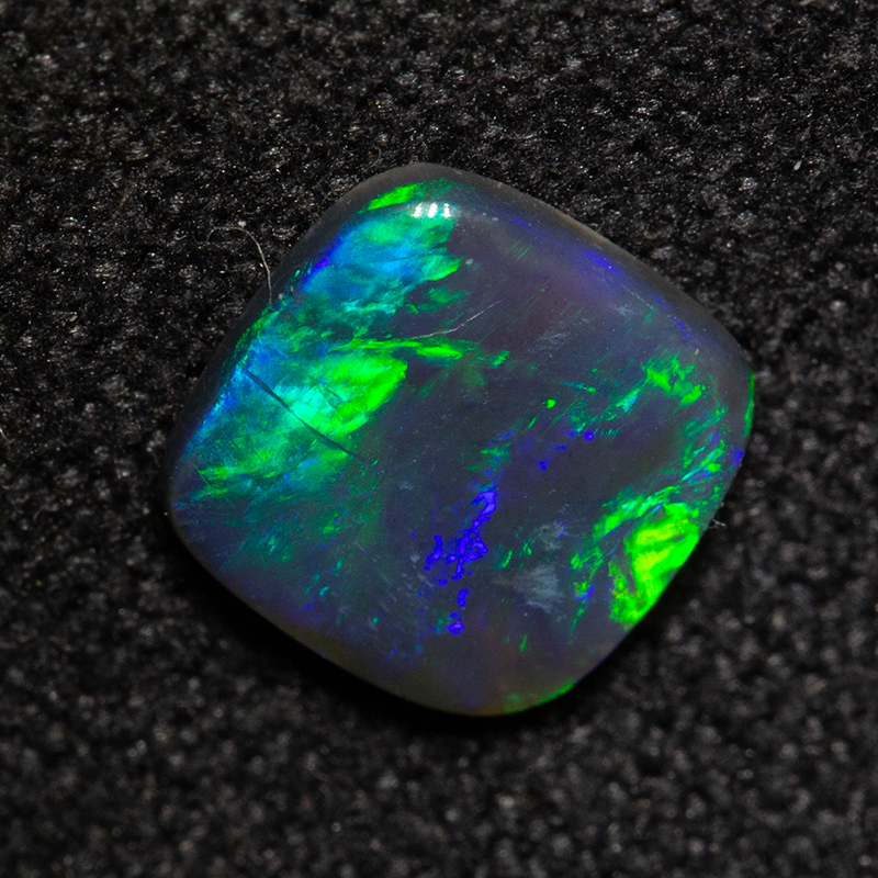 0.56 ct black opal 6.6x6.5x1.6mm