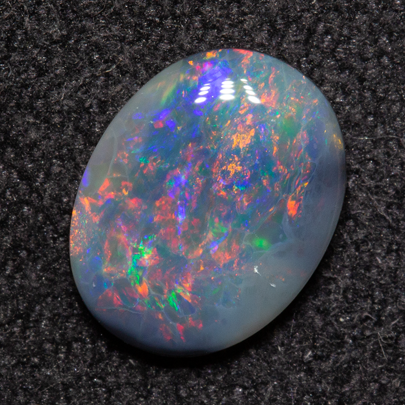 0.68 ct dark opal 8.2x6.4x1.9mm