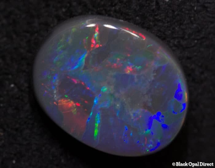 0.70 ct black opal gem 7x5.5x2mm