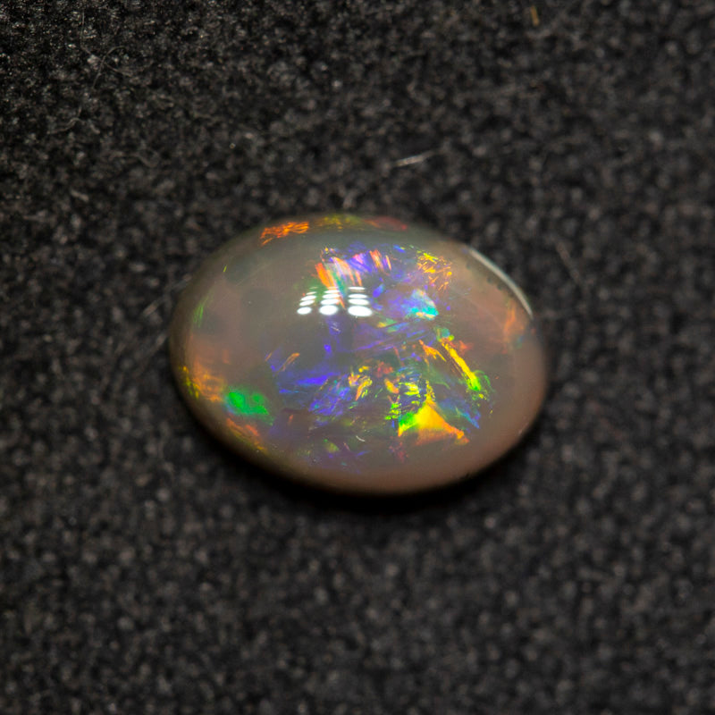 0.75 ct dark opal 6.9x5.1x3.2mm