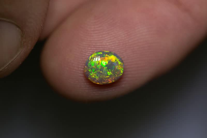 0.81 ct dark opal 7x6x3mm