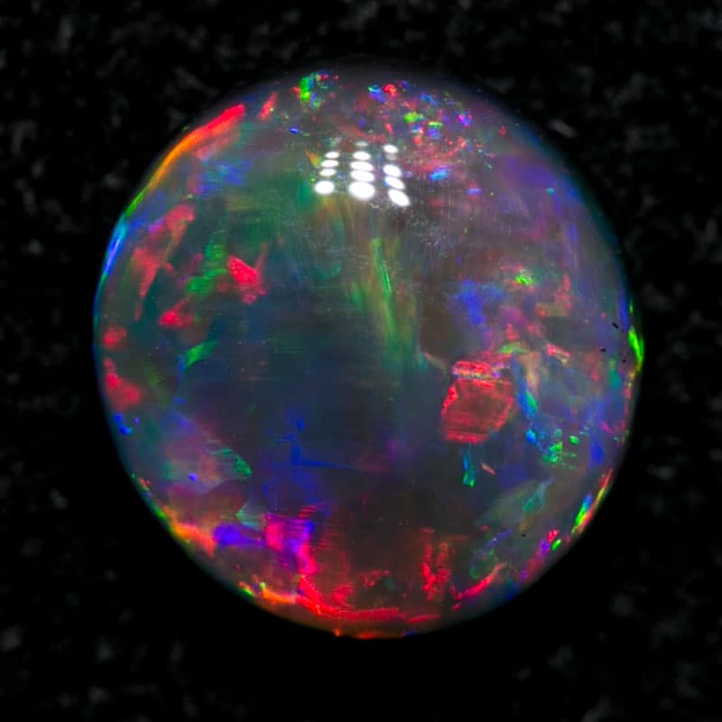 0.84 ct black opal gem 6.3x6x3mm