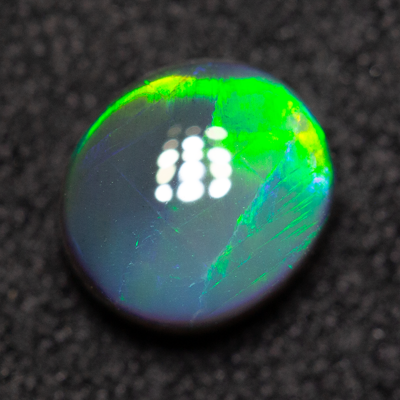 0.88 ct gem black opal 6.5x5.8x3.3m
