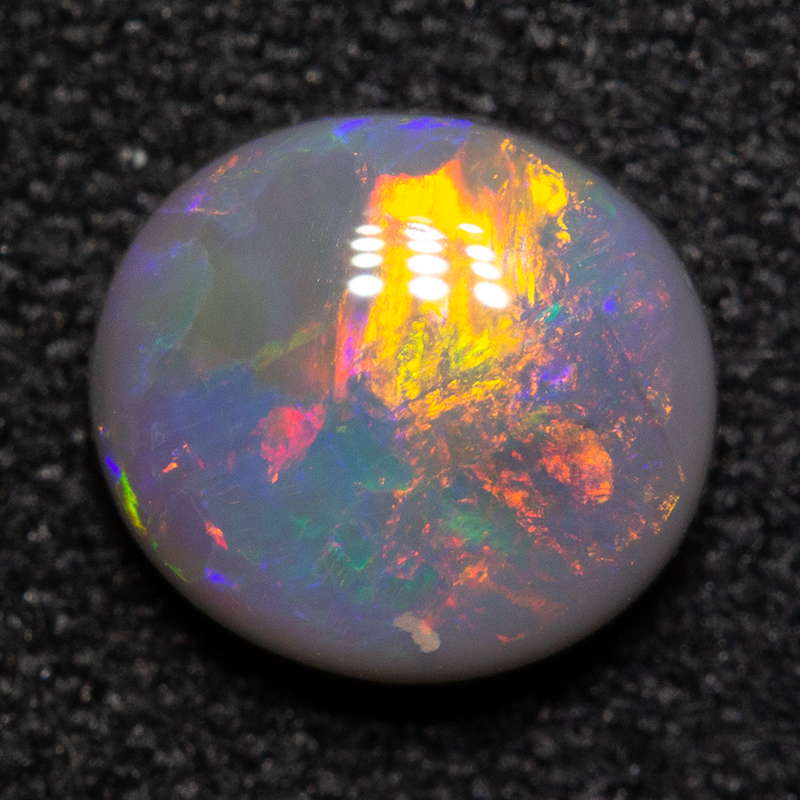 0.91 ct black opal 7x6.5x3mm