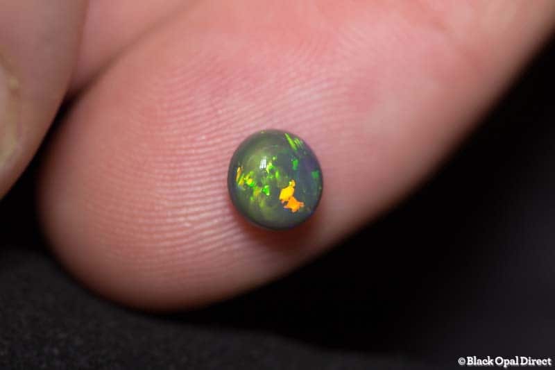 1.06 ct black opal 6mm round x4mm