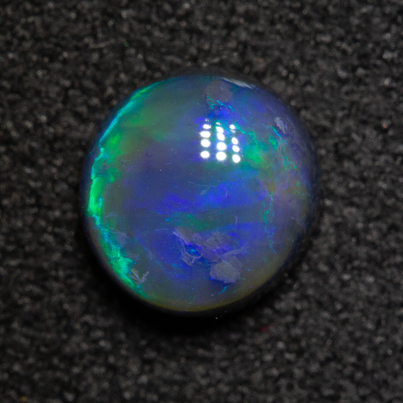 1.08 ct black opal 6.6x6.3x3.9mm