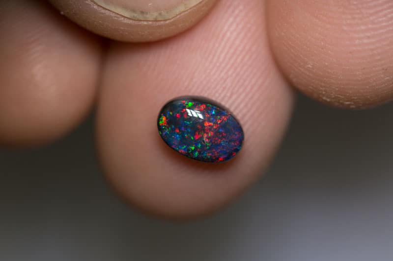 1.13 pigeon blood red black opal 8x5.5x3.5mm