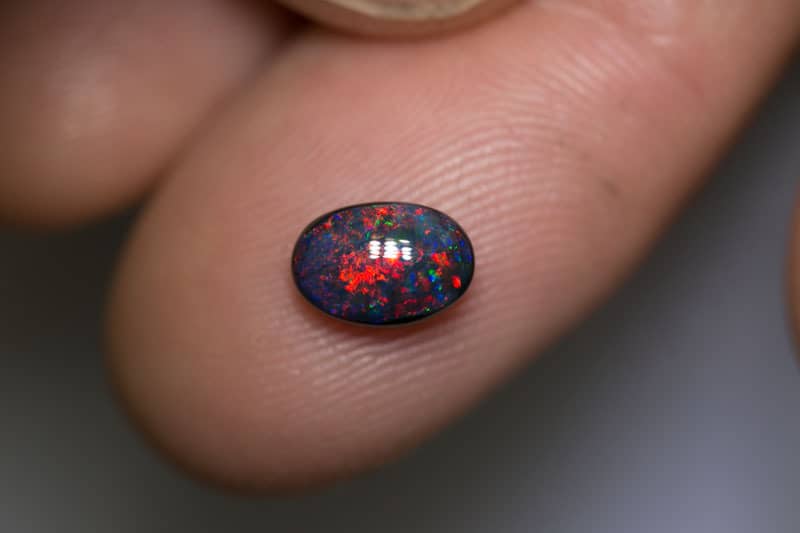1.13 pigeon blood red black opal 8x5.5x3.5mm