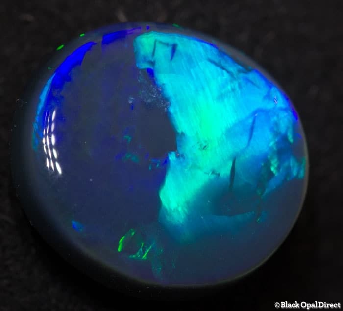 4.84 ct black opal with chinese writing 12.5x11.5x5mm Tim