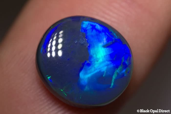 4.84 ct black opal with chinese writing 12.5x11.5x5mm Tim