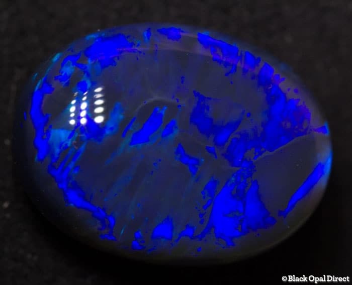 5.85 ct blue opal with chinese writing 14x10.5x6mm