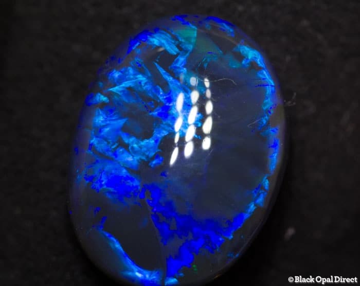 5.85 ct blue opal with chinese writing 14x10.5x6mm