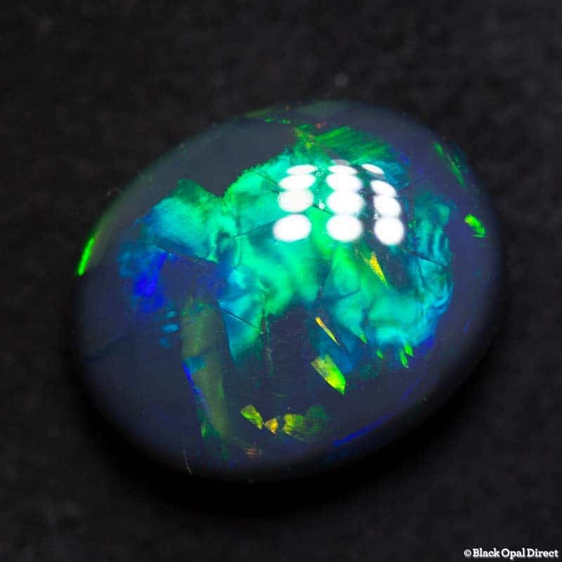 8.79 ct black opal gem with Chinese writing 15x12x7mm