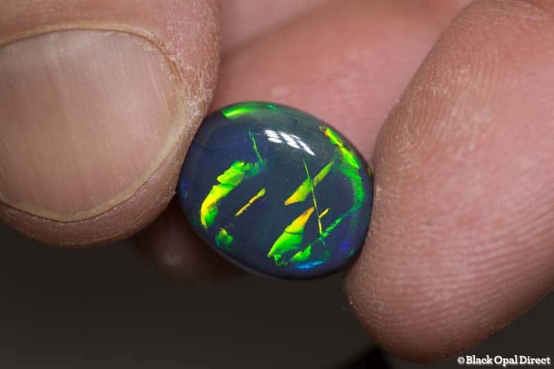8.79 ct black opal gem with Chinese writing 15x12x7mm