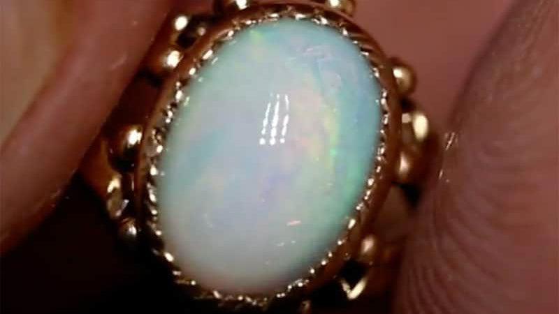 Polishing an antique opal ring: Before and after