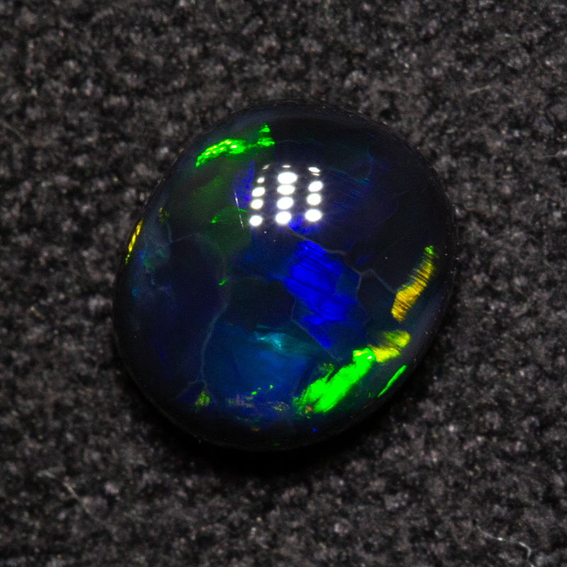 0.49 ct black opal 4.7x5.4x2.6mm