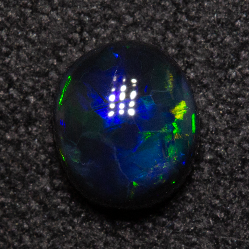 0.49 ct black opal 4.7x5.4x2.6mm