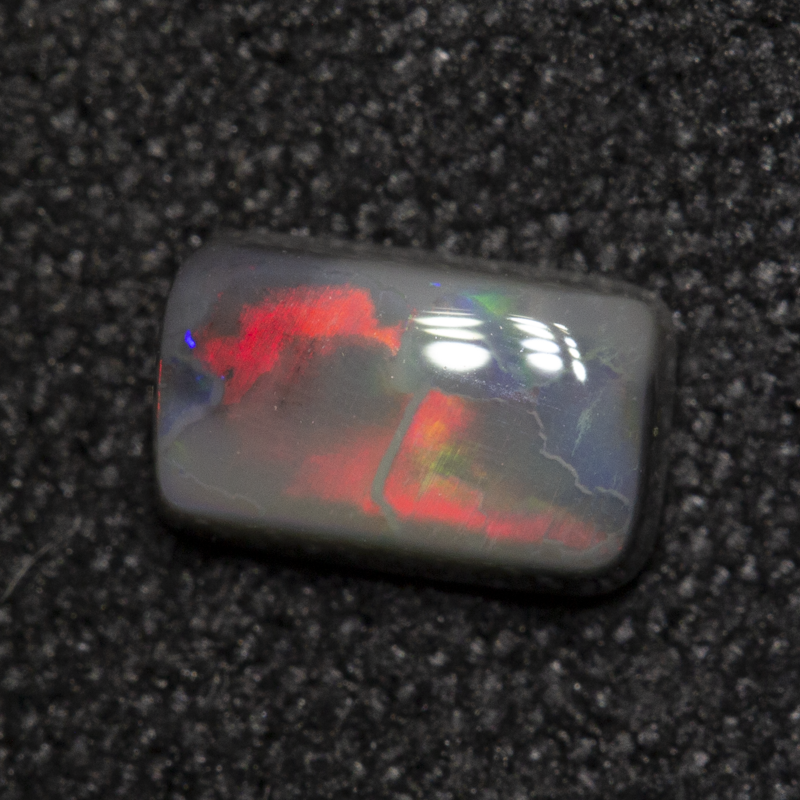 0.49 ct dark opal 6.4x3.9x2.3mm