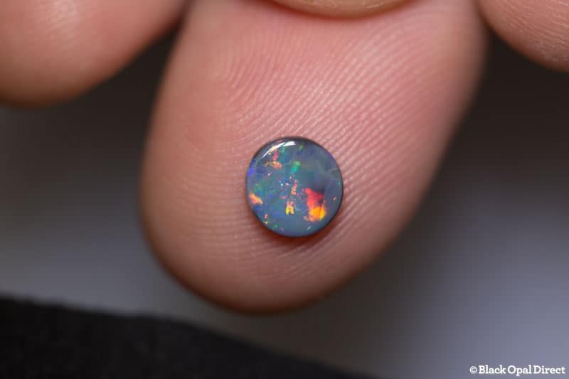 0.52 ct black opal 6mm round x 1.5mm