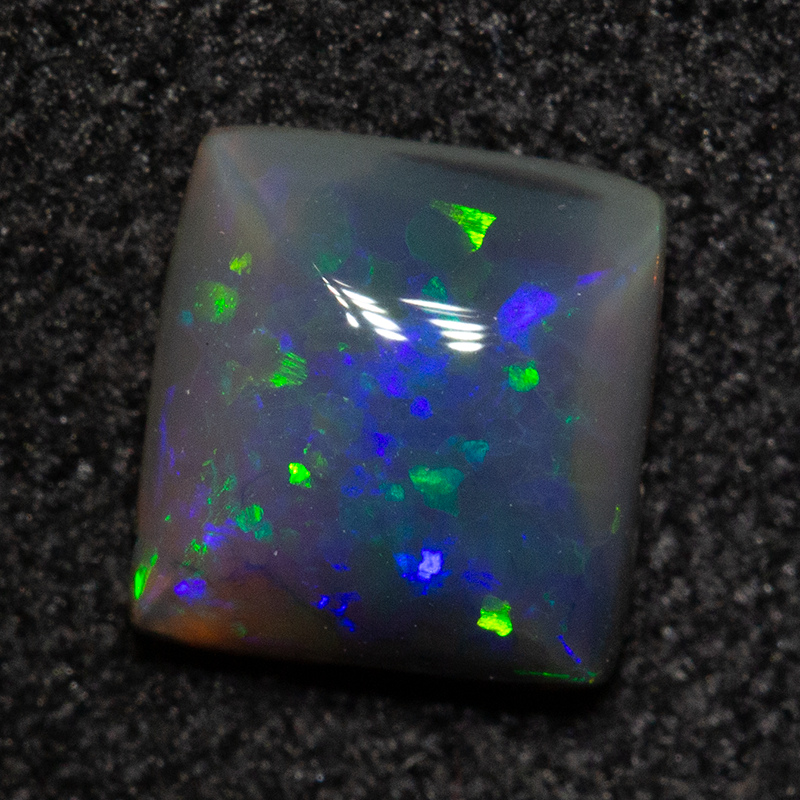0.57 ct black opal 5.7x5.4x2.6mm
