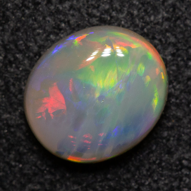 0.67 ct dark opal 6.4x5.5x2.7mm