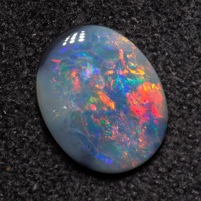 0.68 ct dark opal 8.2x6.4x1.9mm