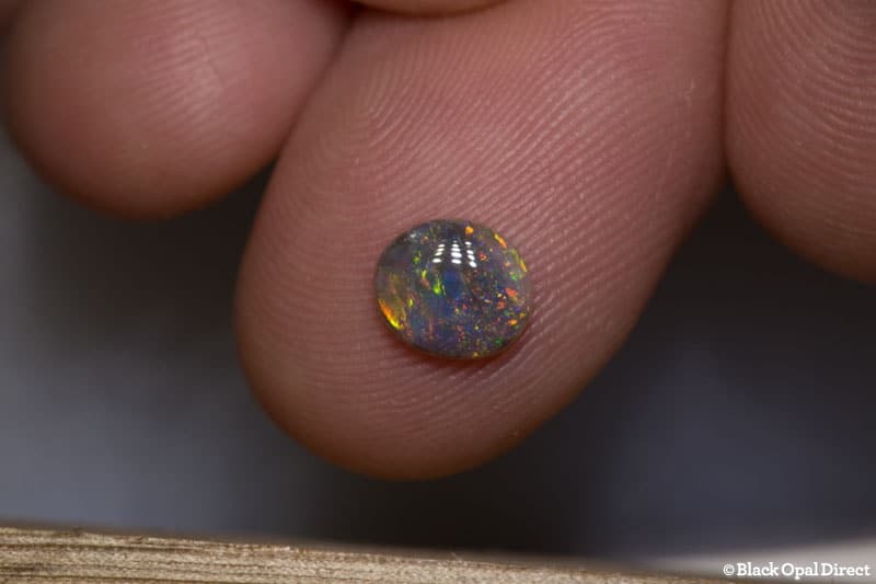 0.68 ct semi black opal 7x6x2mm