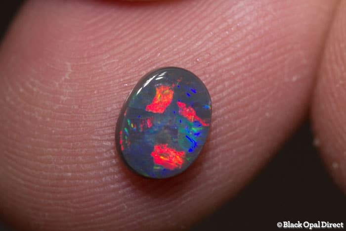 0.70 ct black opal gem 7x5.5x2mm