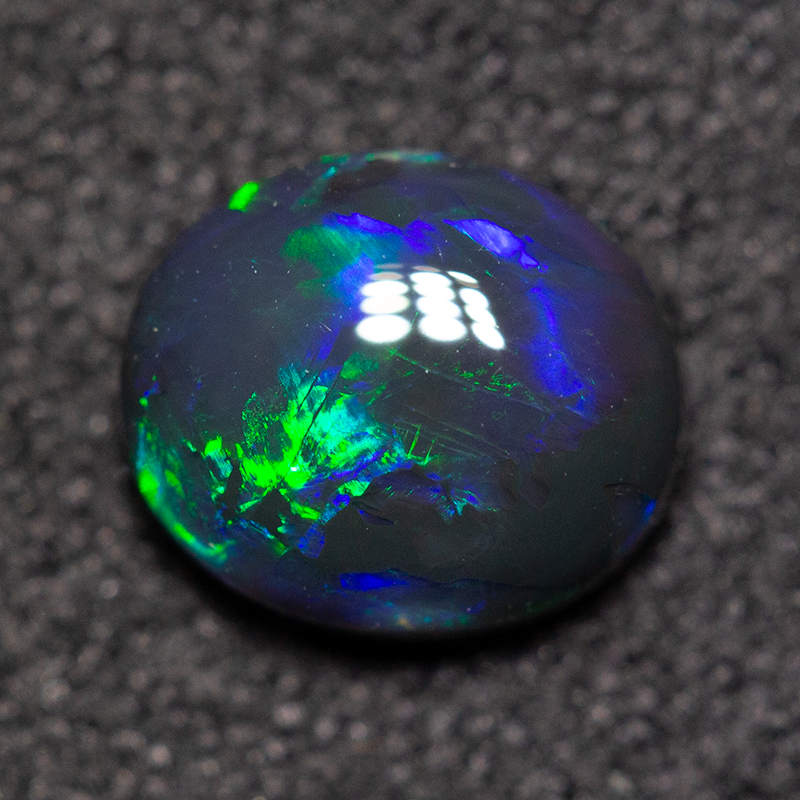 0.74 ct black opal 7x6x3mm