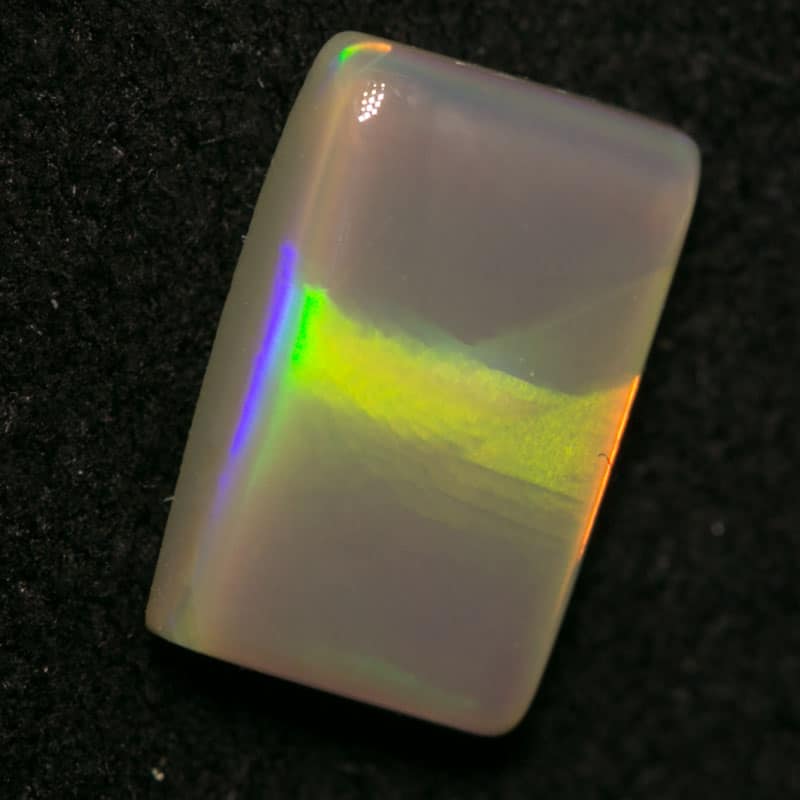 0.79 ct dark opal pillow cut with cats eye pattern 8x5x2mm