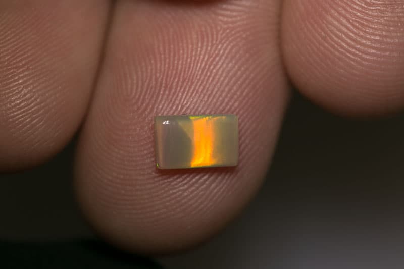0.79 ct dark opal pillow cut with cats eye pattern 8x5x2mm