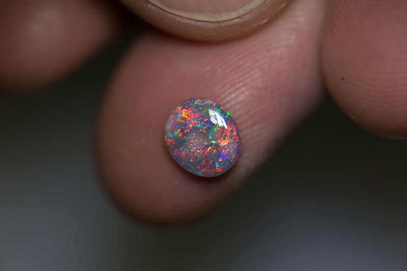 0.79 ct dark opal 7x6.5x2mm