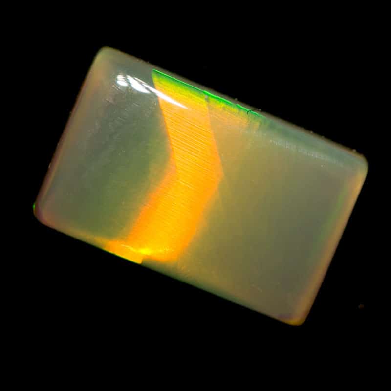 0.79 ct dark opal pillow cut with cats eye pattern 8x5x2mm