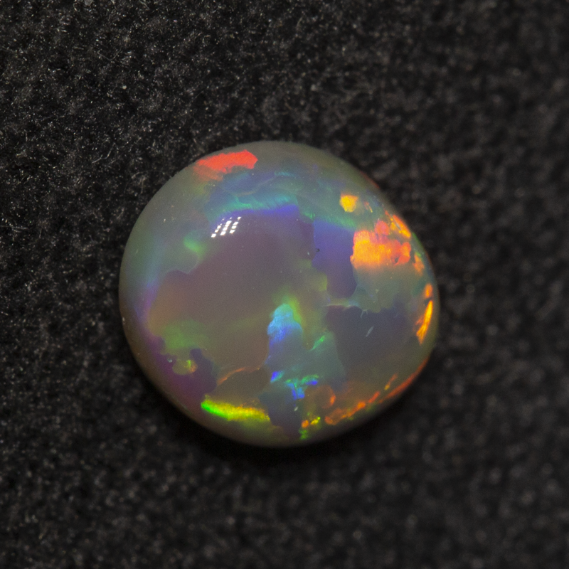 0.81 ct dark opal 8x5.9x2.9mm