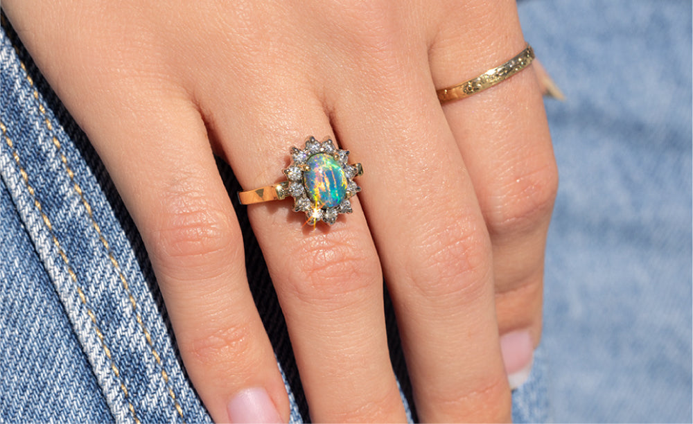 18 kt yellow gold black opal engagement ring with diamonds