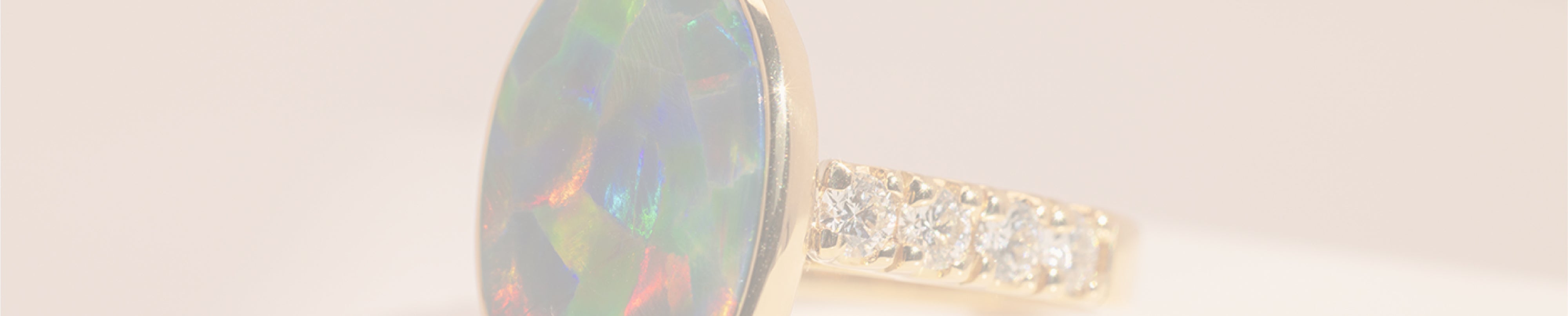 18 kt yellow gold black opal engagement ring with diamonds
